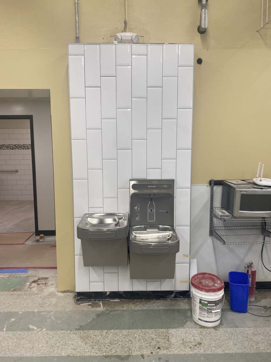 Installed Drinking Fountains Two newly installed water drinking fountains attached to a newly constructed white wall
